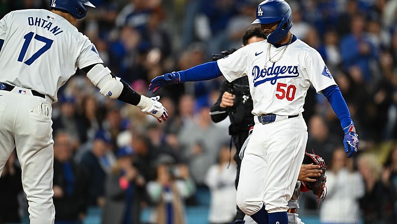 Mar 29, 2024; Los Angeles, California, USA; Los Angeles Dodgers second baseman Mookie Betts (50) hit fives designated hitter Shohei Ohtani (17)after hitting a home run against the St. Louis Cardinals during the first inning at Dodger Stadium. Mandatory Credit: Jonathan Hui-USA TODAY Sports