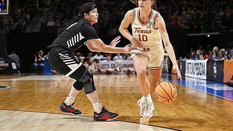 Mar 29, 2024; Portland, OR, USA; Texas Longhorns guard Shay Holle (10) dribbles the basketball during the first half against Gonzaga Bulldogs guard Kaylynne Truong (14) in the semifinals of the Portland Regional of the 2024 NCAA Tournament at the Moda Center at the Moda Center. Mandatory Credit: Troy Wayrynen-USA TODAY Sports