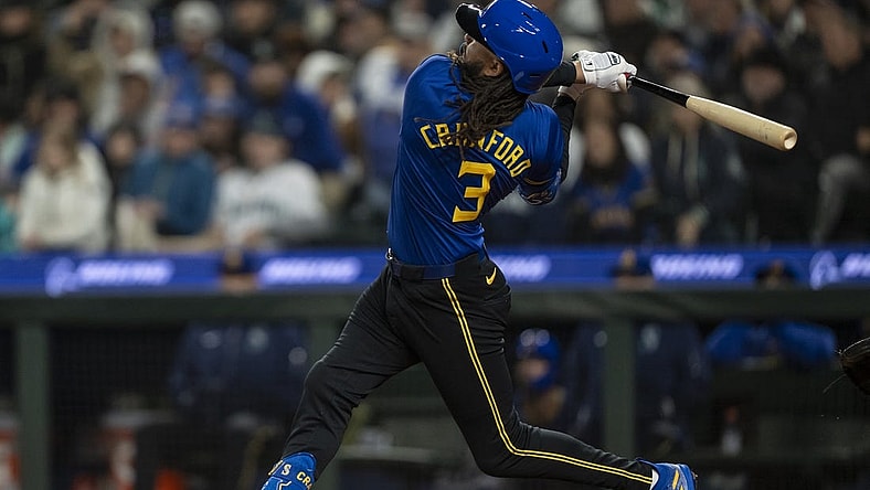Mar 29, 2024; Seattle, Washington, USA; Seattle Mariners shortstop J.P. Crawford (3) hits a solo home run during the sixth inning against the Boston Red Sox at T-Mobile Park. Mandatory Credit: Stephen Brashear-USA TODAY Sports