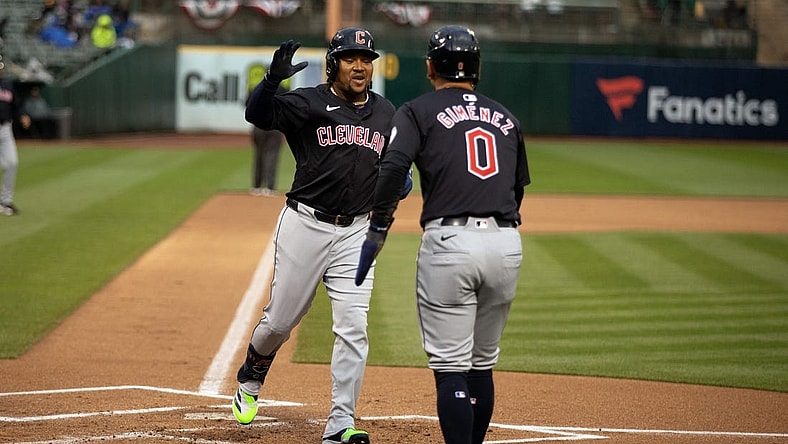 Mar 29, 2024; Oakland, California, USA; Cleveland Guardians third baseman José Ramírez (11) is greeted by teammate Andrés Giménez (0) after hitting a two-run home run against the Oakland Athletics during the first inning at Oakland-Alameda County Coliseum. Mandatory Credit: D. Ross Cameron-USA TODAY Sports
