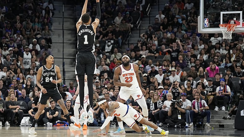 Mar 29, 2024; San Antonio, Texas, USA; San Antonio Spurs forward Victor Wembanyama (1) shoots a three pointer over New York Knicks guard Miles McBride (2) during overtime at Frost Bank Center. Mandatory Credit: Scott Wachter-USA TODAY Sports
