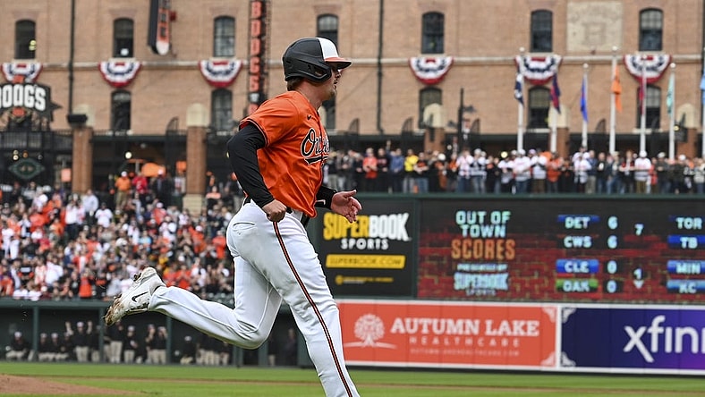 Mar 30, 2024; Baltimore, Maryland, USA;  Baltimore Orioles catcher Adley Rutschman (35) scores on  first baseman Ryan Mountcastle (not pictured) first inning double against the Los Angeles Angels at Oriole Park at Camden Yards. Mandatory Credit: Tommy Gilligan-USA TODAY Sports
