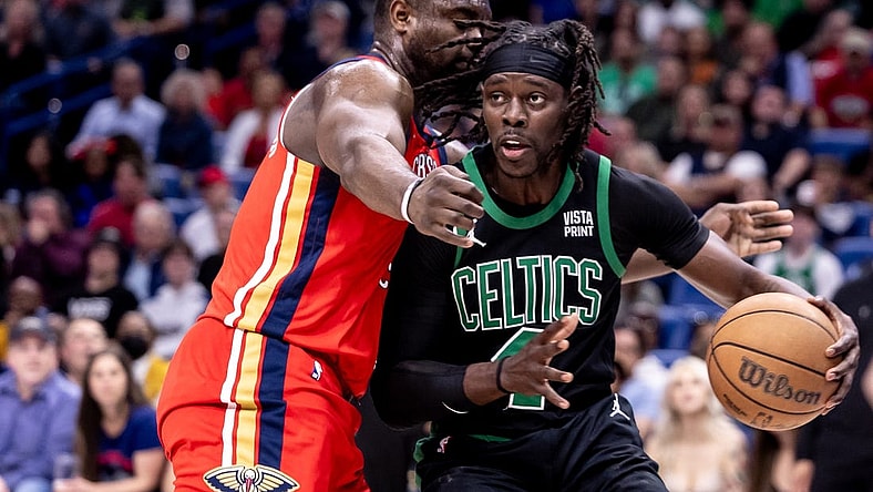 Mar 30, 2024; New Orleans, Louisiana, USA;  Boston Celtics guard Jrue Holiday (4) dribbles against New Orleans Pelicans forward Zion Williamson (1) during the first half at Smoothie King Center. Mandatory Credit: Stephen Lew-USA TODAY Sports