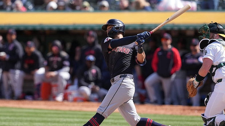 Mar 30, 2024; Oakland, California, USA; Cleveland Guardians center fielder Tyler Freeman (2) hits an RBI single against the Oakland Athletics during the sixth inning at Oakland-Alameda County Coliseum. Mandatory Credit: Darren Yamashita-USA TODAY Sports