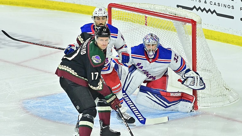 Mar 30, 2024; Tempe, Arizona, USA;  New York Rangers goaltender Jonathan Quick (32) defends as Arizona Coyotes center Nick Bjugstad (17) and center Vincent Trocheck (16) battle for position in the first period at Mullett Arena. Mandatory Credit: Matt Kartozian-USA TODAY Sports