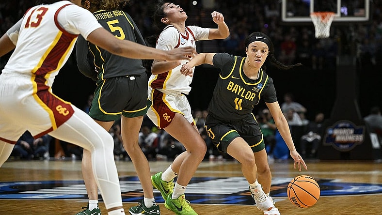 Mar 30, 2024; Portland, OR, USA; Baylor Lady Bears guard Jada Walker (11) drives to the basket during the first half against USC Trojans guard Kayla Padilla (45) in the semifinals of the Portland Regional of the 2024 NCAA Tournament at the Moda Center. Mandatory Credit: Troy Wayrynen-USA TODAY Sports