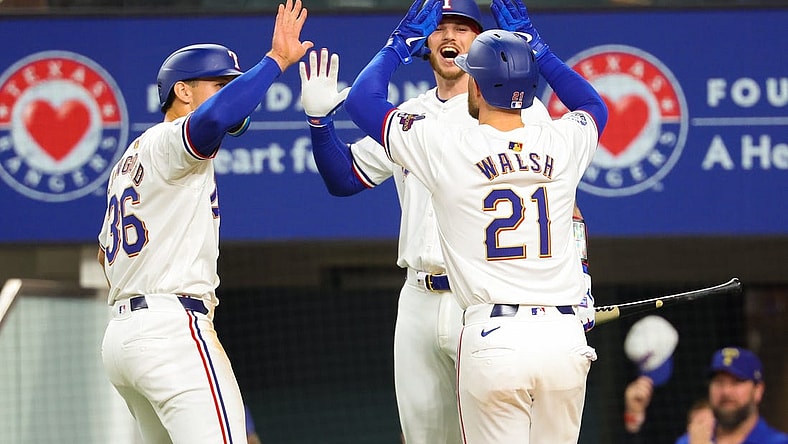 Mar 30, 2024; Arlington, Texas, USA;  Texas Rangers first baseman Jared Walsh (21) celebrates with Texas Rangers designated hitter Wyatt Langford (36) and Texas Rangers catcher Jonah Heim (28) after hitting a two-run home run during the second inning against the Chicago Cubs at Globe Life Field. Mandatory Credit: Kevin Jairaj-USA TODAY Sports