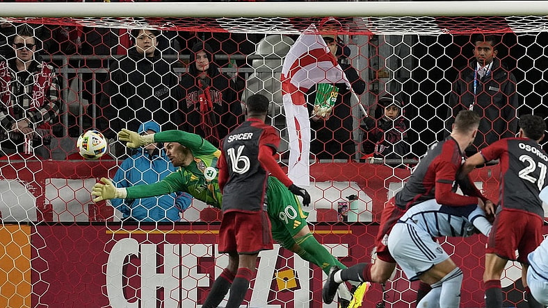 Mar 30, 2024; Toronto, Ontario, USA; Toronto FC goalkeeper Luka Gavran (90) dives to make a stop against Sporting Kansas City during the first half at BMO Field. Mandatory Credit: Nick Turchiaro-USA TODAY Sports