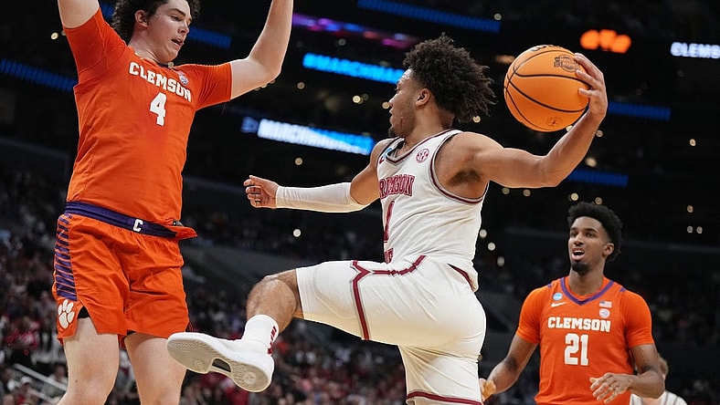 Mar 30, 2024; Los Angeles, CA, USA;  Alabama Crimson Tide guard Mark Sears (1) controls the ball against Clemson Tigers forward Ian Schieffelin (4) in the first half in the finals of the West Regional of the 2024 NCAA Tournament at Crypto.com Arena. Mandatory Credit: Kirby Lee-USA TODAY Sports