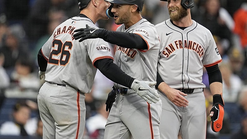 Mar 30, 2024; San Diego, California, USA; San Francisco Giants left fielder Michael Conforto (center) is congratulated by third baseman Matt Chapman (26) after hitting a grand slam home run against the San Diego Padres during the eighth inning at Petco Park. Mandatory Credit: Ray Acevedo-USA TODAY Sports