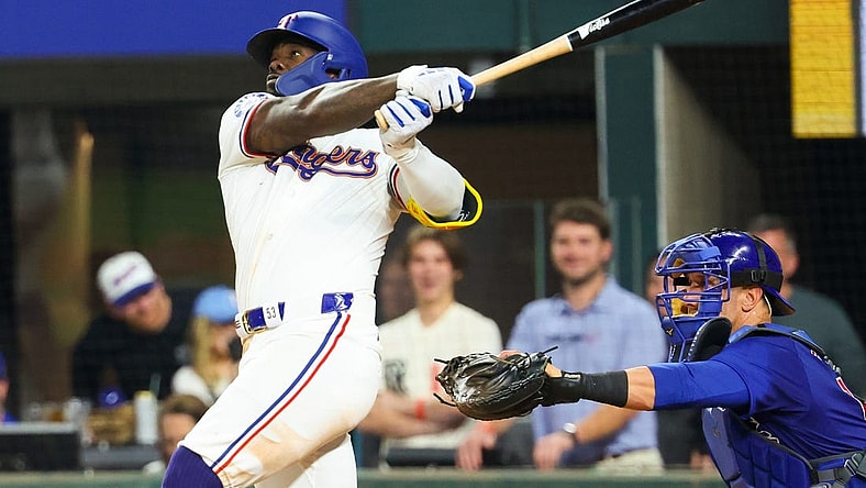Mar 30, 2024; Arlington, Texas, USA;  Texas Rangers right fielder Adolis Garcia (53) hits a sacrifice fly rbi during the eighth inning against the Chicago Cubs at Globe Life Field. Mandatory Credit: Kevin Jairaj-USA TODAY Sports