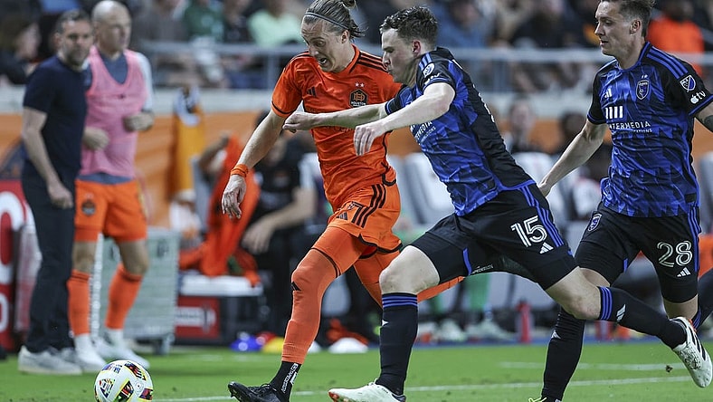 Mar 30, 2024; Houston, Texas, USA; Houston Dynamo FC midfielder Griffin Dorsey (25) attempts to advance the ball as San Jose Earthquakes defender Tanner Beason (15) defends during the second half at Shell Energy Stadium. Mandatory Credit: Troy Taormina-USA TODAY Sports