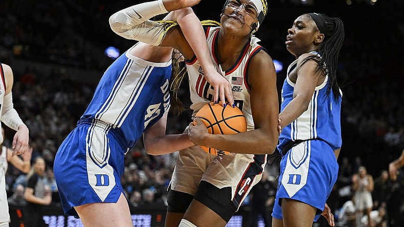 Mar 30, 2024; Portland, OR, USA; UConn Huskies forward Aaliyah Edwards (3) is fouled by Duke Blue Devils center Kennedy Brown (42) during the second half in the semifinals of the Portland Regional of the 2024 NCAA Tournament at the Moda Center. Mandatory Credit: Troy Wayrynen-USA TODAY Sports