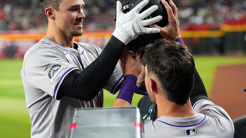 Mar 30, 2024; Phoenix, Arizona, USA; Colorado Rockies center fielder Brenton Doyle (9) celebrates with teammates in the dugout after hitting a two run home run against the Arizona Diamondbacks during the eighth inning at Chase Field. Mandatory Credit: Joe Camporeale-USA TODAY Sports