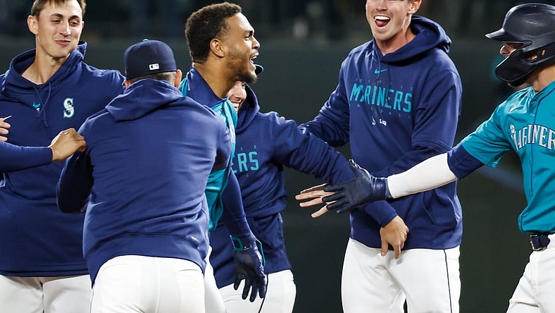 Mar 30, 2024; Seattle, Washington, USA; Seattle Mariners center fielder Julio Rodriguez (44, middle) celebrates after hitting a walk-off RBI-single against the Boston Red Sox during the tenth inning at T-Mobile Park. Mandatory Credit: Joe Nicholson-USA TODAY Sports