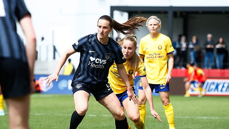 Mar 31, 2024; Washington, District of Columbia, USA; Washington Spirit midfielder Andi Sullivan (12) dribbles the ball against Utah Royals FC midfielder Dana Foederer (22) during the first half of the match at Audi Field. Mandatory Credit: Amber Searls-USA TODAY Sports
