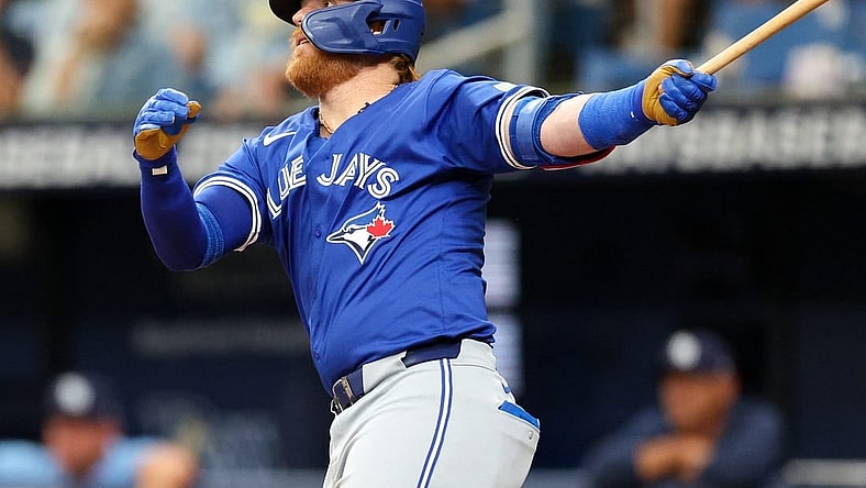 Mar 31, 2024; St. Petersburg, Florida, USA;  Toronto Blue Jays third baseman Justin Turner (2) hits a solo home run against the Tampa Bay Rays in the fifth inning at Tropicana Field. Mandatory Credit: Nathan Ray Seebeck-USA TODAY Sports