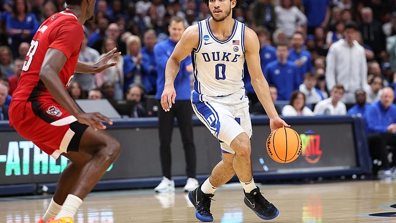 Mar 31, 2024; Dallas, TX, USA; Duke Blue Devils guard Jared McCain (0) controls the ball against North Carolina State Wolfpack forward Mohamed Diarra (23) in the first half in the finals of the South Regional of the 2024 NCAA Tournament at American Airline Center. Mandatory Credit: Kevin Jairaj-USA TODAY Sports