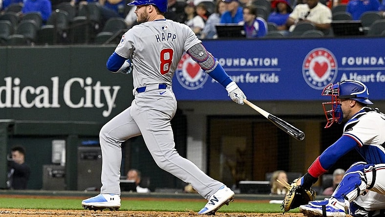 Mar 31, 2024; Arlington, Texas, USA; Chicago Cubs designated hitter Ian Happ (8) hits a double and drives in two runs during the fourth inning against the Texas Rangers at Globe Life Field. Mandatory Credit: Jerome Miron-USA TODAY Sports
