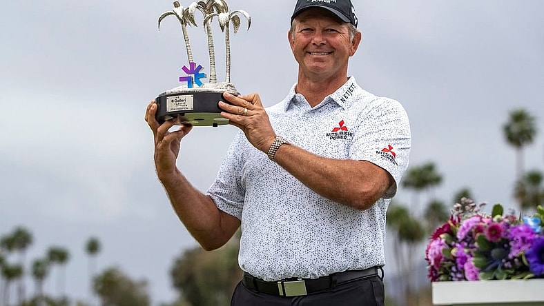 Retief Goosen holds up the Galleri Classic trophy after the final round at Mission Hills Country Club in Rancho Mirage, Calif., Sunday, March 31, 2024.
