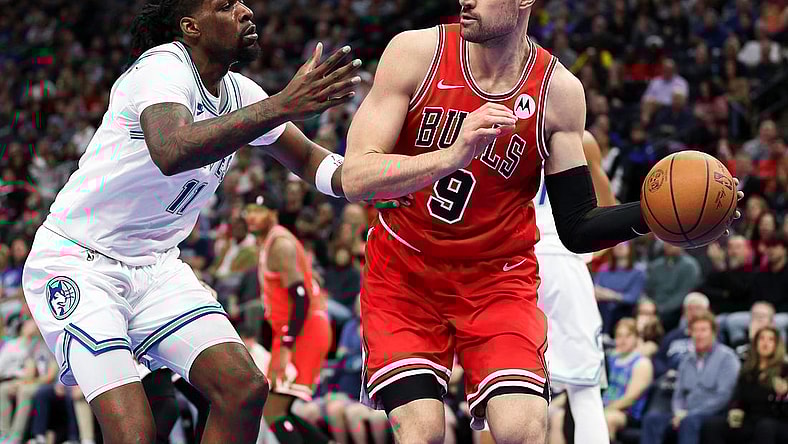 Mar 31, 2024; Minneapolis, Minnesota, USA; Chicago Bulls center Nikola Vucevic (9) passes as Minnesota Timberwolves center Naz Reid (11) defends during the first half at Target Center. Mandatory Credit: Matt Krohn-USA TODAY Sports