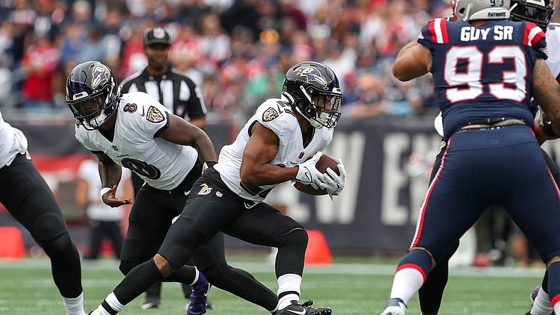 Sep 25, 2022; Foxborough, Massachusetts, USA; Baltimore Ravens running back JK Dobbins (27) runs the ball during the first half against the New England Patriots at Gillette Stadium. Mandatory Credit: Paul Rutherford-USA TODAY Sports
