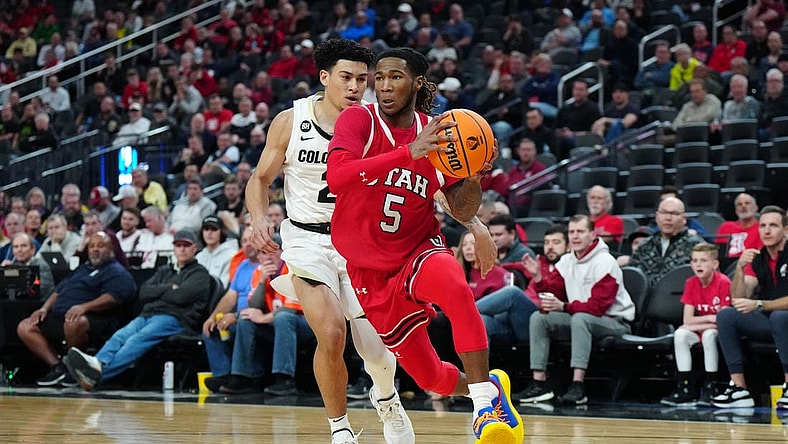 Mar 14, 2024; Las Vegas, NV, USA; Utah Utes guard Deivon Smith (5) drives to the basket against Colorado Buffaloes guard KJ Simpson (2) in the first half at T-Mobile Arena. Mandatory Credit: Kirby Lee-USA TODAY Sports