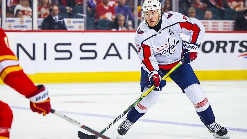 Mar 18, 2024; Calgary, Alberta, CAN; Washington Capitals right wing T.J. Oshie (77) controls the puck against the Calgary Flames during the third period at Scotiabank Saddledome. Mandatory Credit: Sergei Belski-USA TODAY Sports