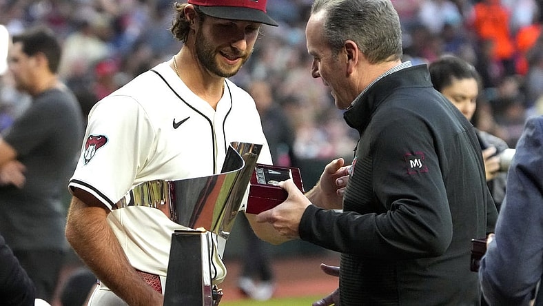 Mar 29, 2024; Phoenix, Arizona, USA; Arizona Diamondbacks President/CEO Derrick Hall presents pitcher Zac Gallen (23) a National League Championship Ring before a game against the Colorado Rockies at Chase Field. Mandatory Credit: Rick Scuteri-USA TODAY Sports