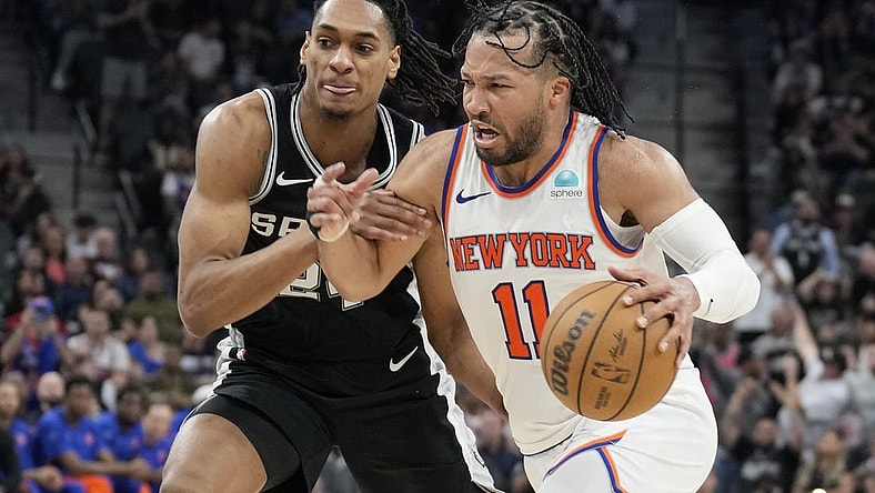 Mar 29, 2024; San Antonio, Texas, USA; New York Knicks guard Jalen Brunson (11) drives to the basket while defended by San Antonio Spurs guard Devin Vassell (24) during overtime at Frost Bank Center. Mandatory Credit: Scott Wachter-USA TODAY Sports