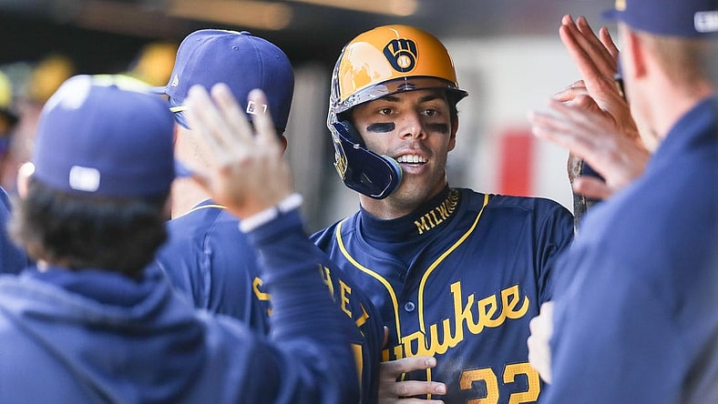 Mar 31, 2024; New York City, New York, USA;  Milwaukee Brewers left fielder Christian Yelich (22) is greeted in the dugout after scoring in the first inning against the New York Mets at Citi Field. Mandatory Credit: Wendell Cruz-USA TODAY Sports