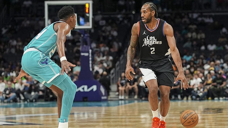 Mar 31, 2024; Charlotte, North Carolina, USA; LA Clippers forward Kawhi Leonard (2) on the dribble against Charlotte Hornets forward Brandon Miller (24) during the second half at Spectrum Center. Mandatory Credit: Jim Dedmon-USA TODAY Sports