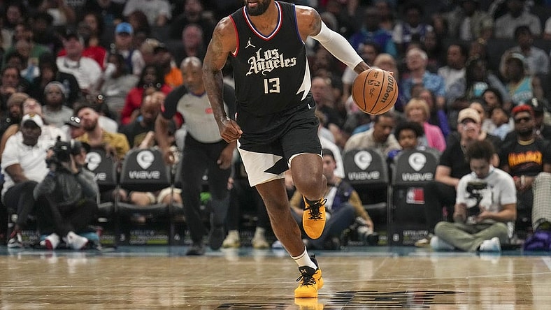 Mar 31, 2024; Charlotte, North Carolina, USA; LA Clippers forward Paul George (13) brings the ball up court against the Charlotte Hornets during the second half at Spectrum Center. Mandatory Credit: Jim Dedmon-USA TODAY Sports