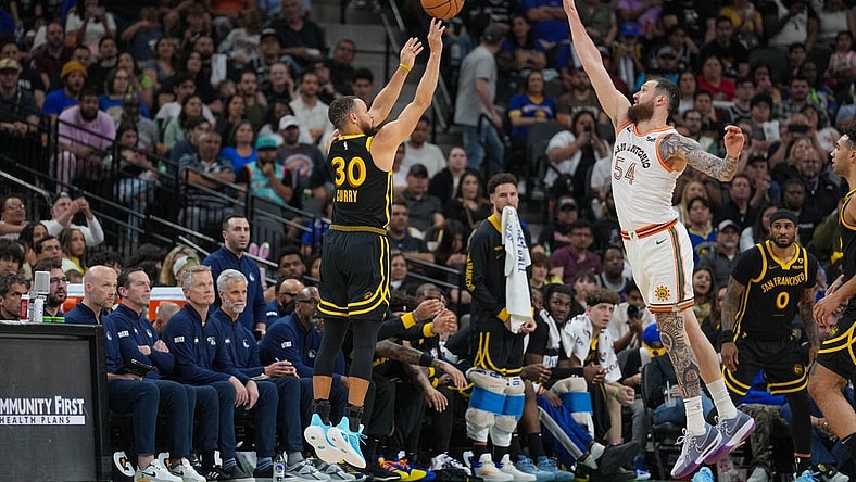 Mar 31, 2024; San Antonio, Texas, USA;  San Antonio Spurs forward Julian Champagnie (30) shoots over San Antonio Spurs forward Sandro Mamukelashvili (54) in the second half at Frost Bank Center. Mandatory Credit: Daniel Dunn-USA TODAY Sports