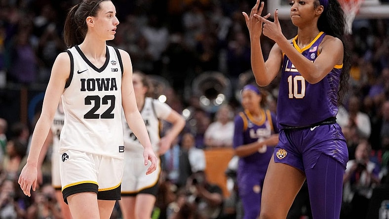 Angel Reese (10) shows Iowa Caitlin Clark her ring finger during the final seconds of the women's NCAA Tournament national championship game.

Syndication Hawkcentral