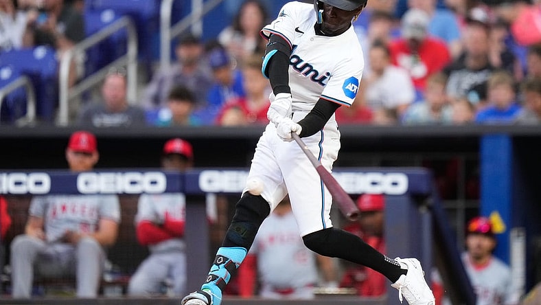Apr 1, 2024; Miami, Florida, USA; Miami Marlins left fielder Nick Gordon (1) hits a single against the Los Angeles Angels during the first inning at loanDepot Park. Mandatory Credit: Rich Storry-USA TODAY Sports