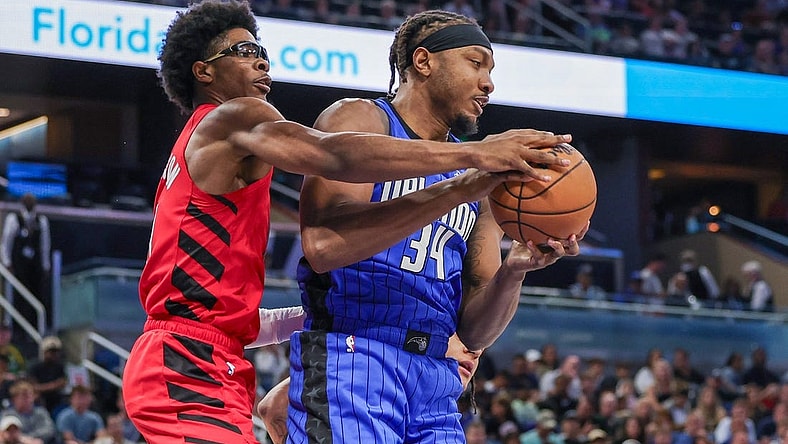 Apr 1, 2024; Orlando, Florida, USA; Orlando Magic center Wendell Carter Jr. (34) grabs the rebound from Portland Trail Blazers guard Scoot Henderson (00) during the first quarter at Amway Center. Mandatory Credit: Mike Watters-USA TODAY Sports
