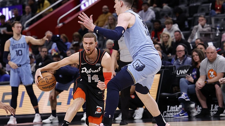 Apr 1, 2024; Detroit, Michigan, USA;  d14 dribbles defended by Memphis Grizzlies forward Jake LaRavia (3) in the first half at Little Caesars Arena. Mandatory Credit: Rick Osentoski-USA TODAY Sports