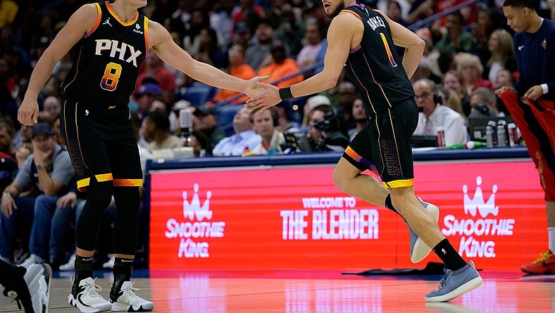 Apr 1, 2024; New Orleans, Louisiana, USA; Phoenix Suns guard Devin Booker (1) celebrates with Phoenix Suns guard Grayson Allen (8) against the New Orleans Pelicans during the first half at Smoothie King Center. Mandatory Credit: Matthew Hinton-USA TODAY Sports