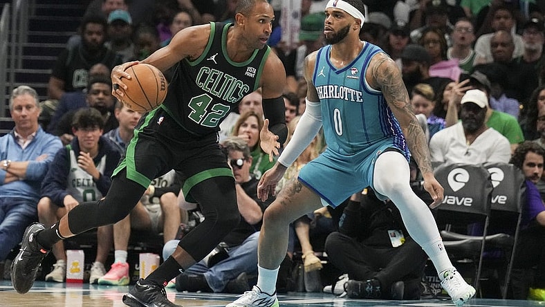 Apr 1, 2024; Charlotte, North Carolina, USA; Boston Celtics center Al Horford (42) drives against Charlotte Hornets forward Miles Bridges (0) during the second half at Spectrum Center. Mandatory Credit: Jim Dedmon-USA TODAY Sports