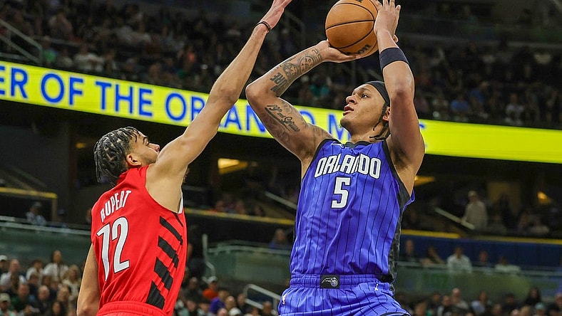 Apr 1, 2024; Orlando, Florida, USA; Orlando Magic forward Paolo Banchero (5) shoots the ball against Portland Trail Blazers guard Rayan Rupert (72) during the second half at Amway Center. Mandatory Credit: Mike Watters-USA TODAY Sports