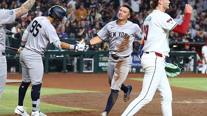 Apr 1, 2024; Phoenix, Arizona, USA; New York Yankees shortstop Anthony Volpe (center) celebrates with teammates after scoring against the Arizona Diamondbacks in the third inning at Chase Field. Mandatory Credit: Mark J. Rebilas-USA TODAY Sports