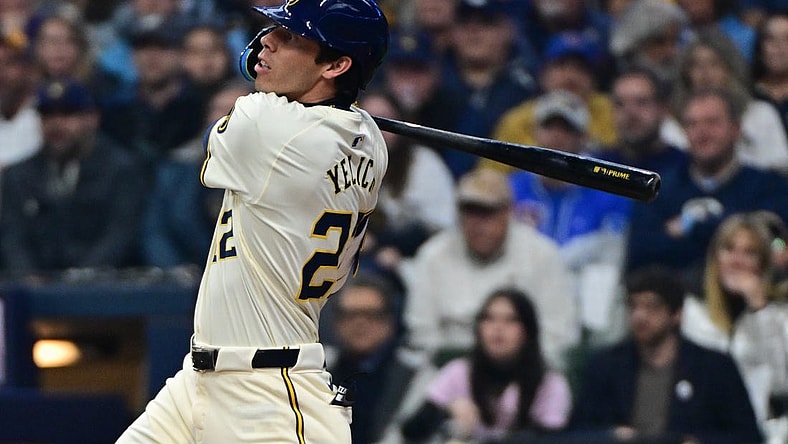 Apr 2, 2024; Milwaukee, Wisconsin, USA; Milwaukee Brewers left fielder Christian Yelich (22) hits a solo home run in the third inning against the Minnesota Twins at American Family Field. Mandatory Credit: Benny Sieu-USA TODAY Sports