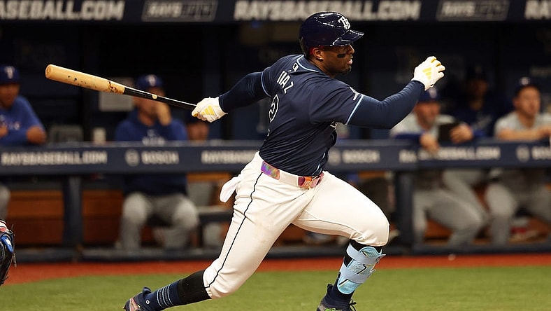 Apr 2, 2024; St. Petersburg, Florida, USA; Tampa Bay Rays first baseman Yandy Diaz (2) hits a RBI single during the third inning against the Texas Rangers at Tropicana Field. Mandatory Credit: Kim Klement Neitzel-USA TODAY Sports