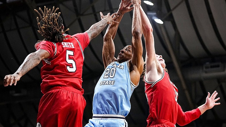 Indiana State Sycamores guard Jayson Kent (20) reaches for the ball against Utah Utes guard Deivon Smith (5) on Tuesday, April 2, 2024, during the NIT semifinals at Hinkle Fieldhouse in Indianapolis.