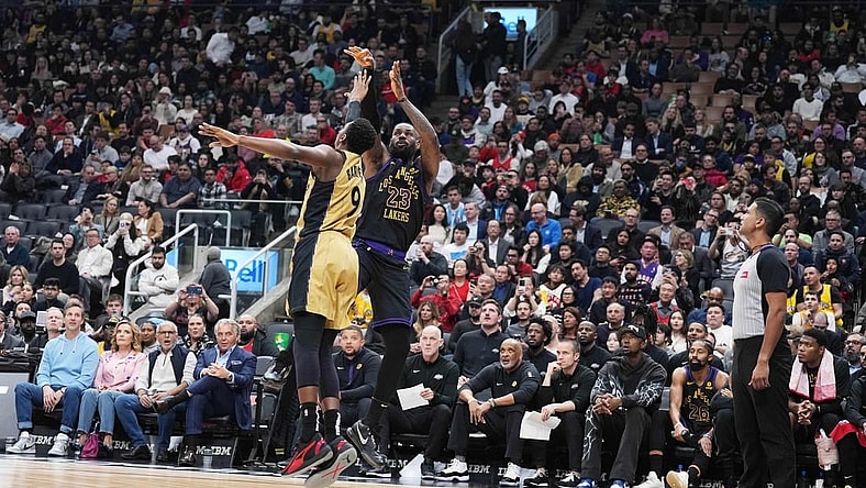 Apr 2, 2024; Toronto, Ontario, CAN; Los Angeles Lakers forward LeBron James (23) shoots the ball at the basket as Toronto Raptors guard RJ Barrett (9) tries to defend  during the second quarter at Scotiabank Arena. Mandatory Credit: Nick Turchiaro-USA TODAY Sports