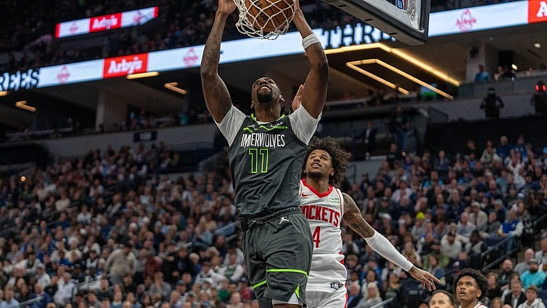 Apr 2, 2024; Minneapolis, Minnesota, USA; Minnesota Timberwolves center Naz Reid (11) dunks over Houston Rockets guard Jalen Green (4) in the second quarter at Target Center. Mandatory Credit: Matt Blewett-USA TODAY Sports