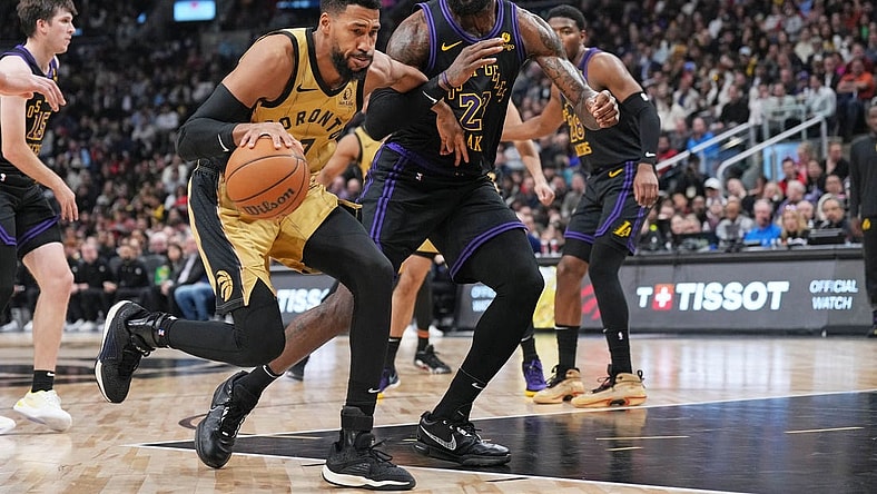 Apr 2, 2024; Toronto, Ontario, CAN; Toronto Raptors forward Garrett Temple (17) controls the ball as Los Angeles Lakers forward LeBron James (23) tries to defend during the third quarter at Scotiabank Arena. Mandatory Credit: Nick Turchiaro-USA TODAY Sports