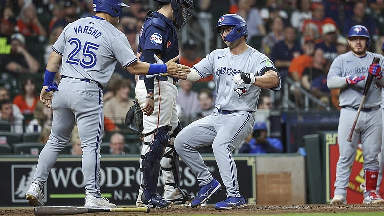 Apr 2, 2024; Houston, Texas, USA; Toronto Blue Jays left fielder Davis Schneider (36) celebrates with left fielder Daulton Varsho (25) after hitting a home run during the ninth inning against the Houston Astros at Minute Maid Park. Mandatory Credit: Troy Taormina-USA TODAY Sports