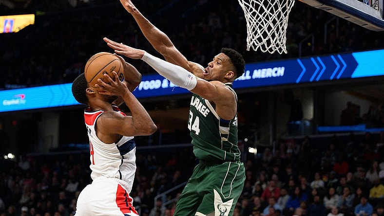 Apr 2, 2024; Washington, District of Columbia, USA; Milwaukee Bucks forward Giannis Antetokounmpo (34) defends against Washington Wizards guard Jared Butler (4) during the fourth quarter at Capital One Arena. Mandatory Credit: Reggie Hildred-USA TODAY Sports